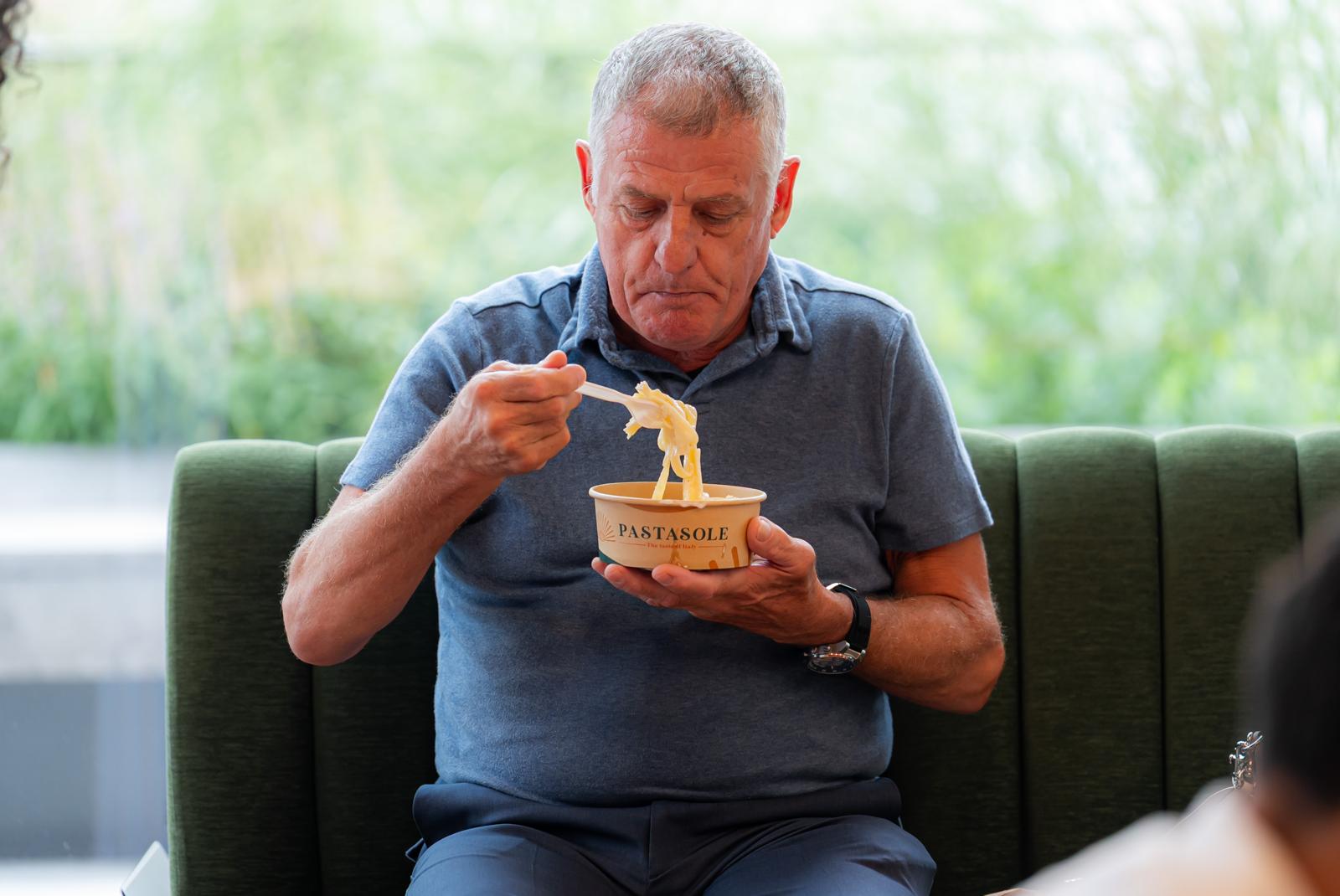 Guest enjoying Pastasole pasta at a catered event