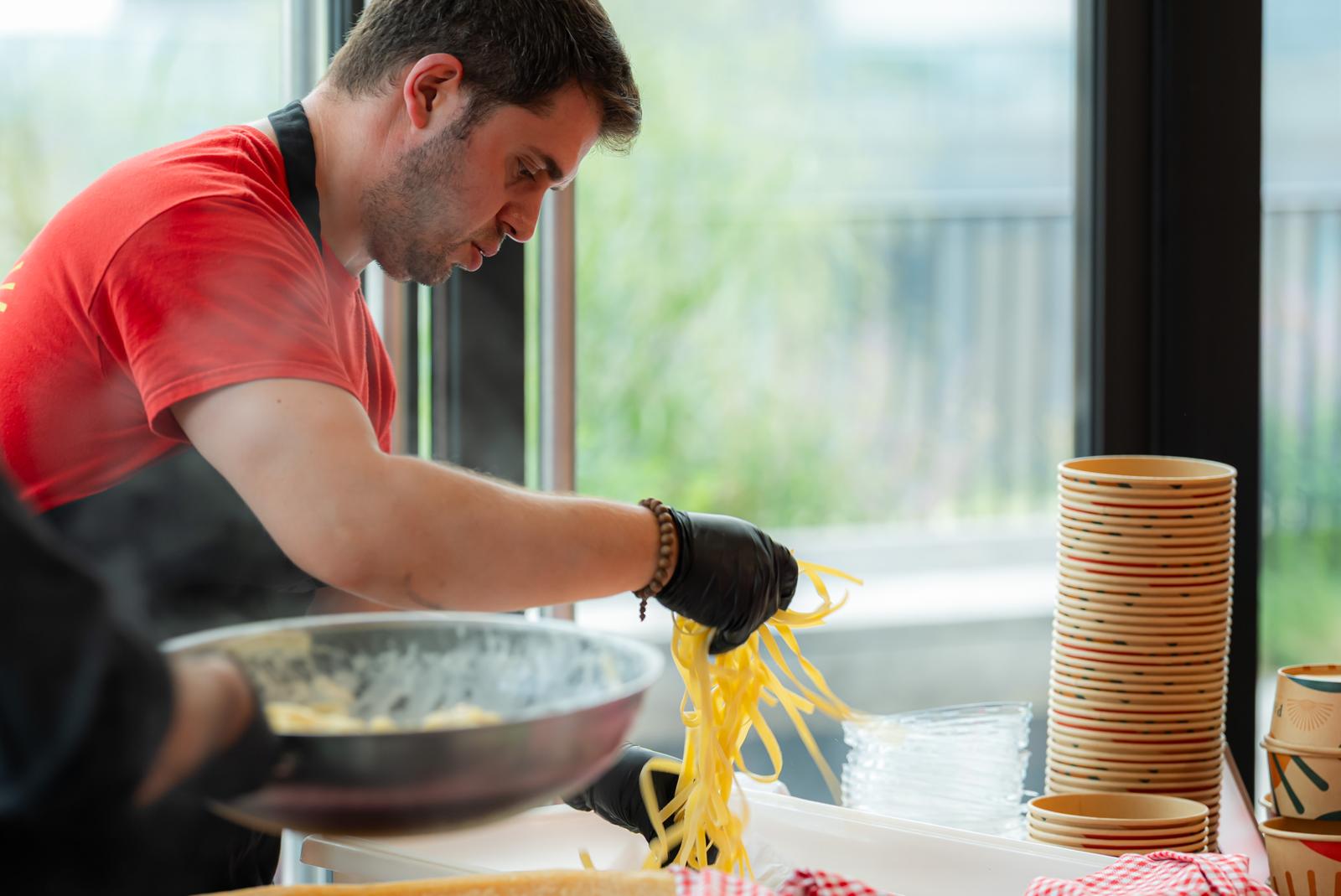 Fresh pasta going from the pan into a Pastasole bowl