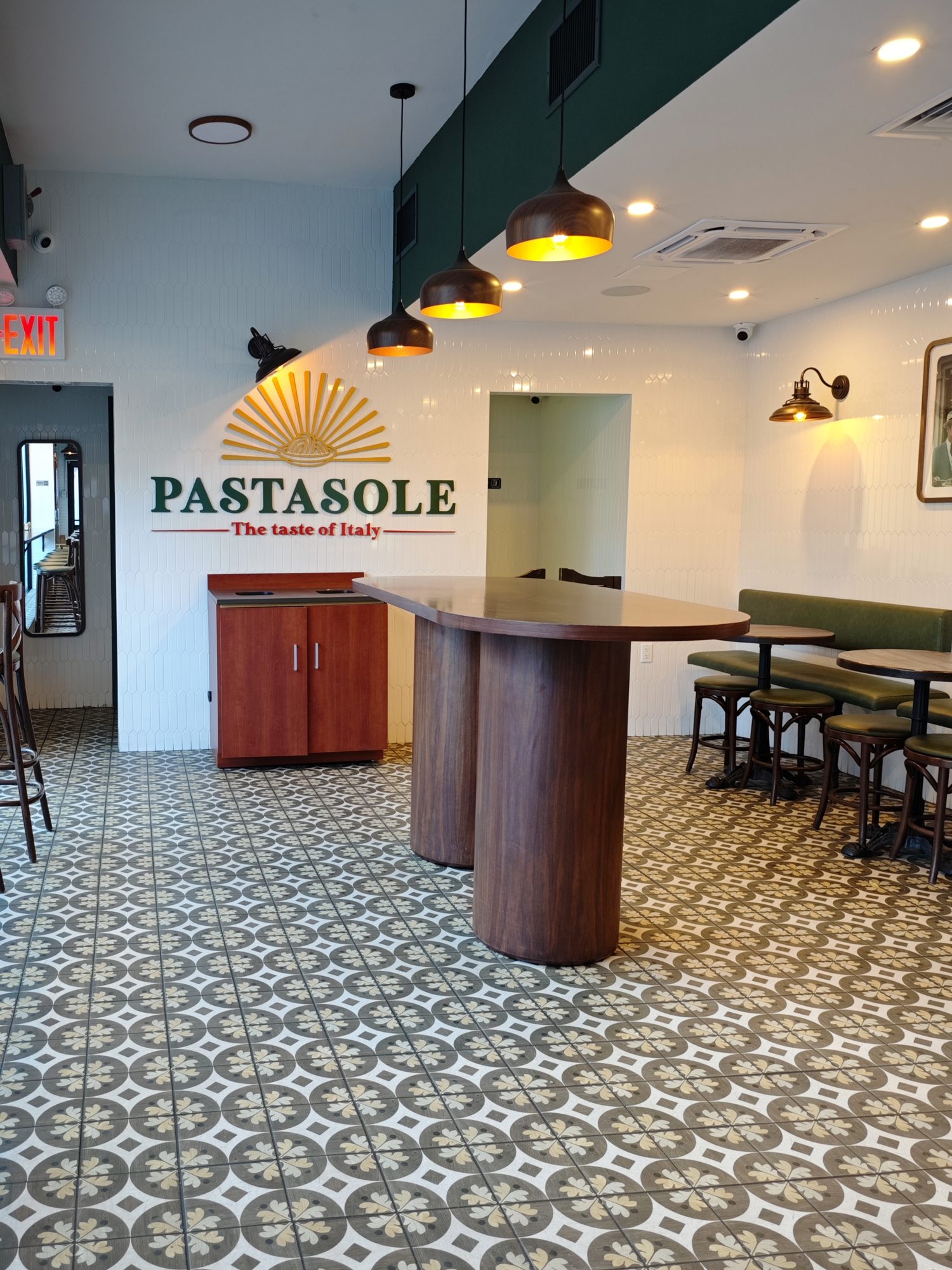 Dining room at Pastasole Chelsea with banquette seating and patterned tile floor