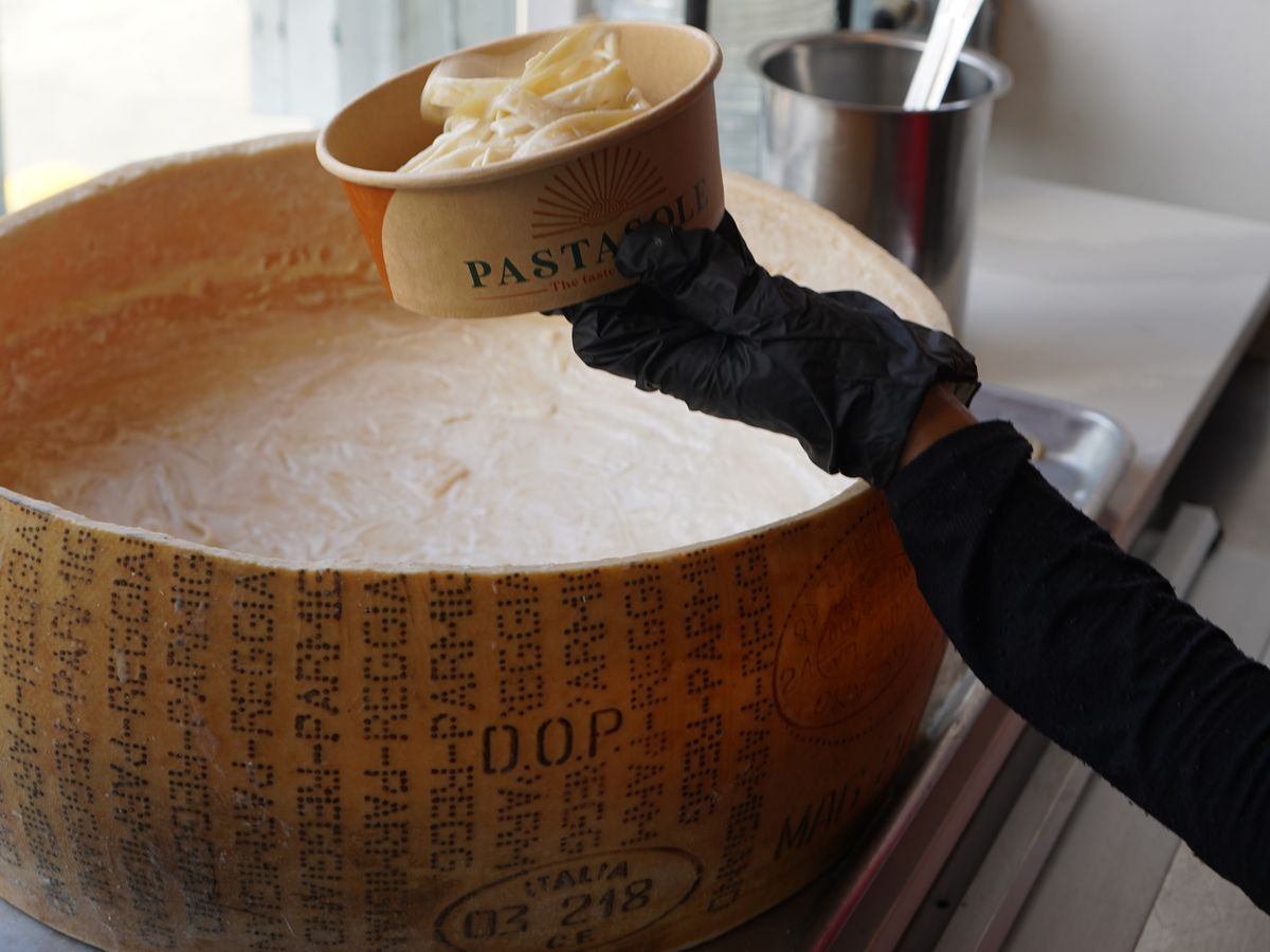 Fettuccine Alfredo served into a Pastasole bowl from a Parmigiano Reggiano D.O.P. wheel