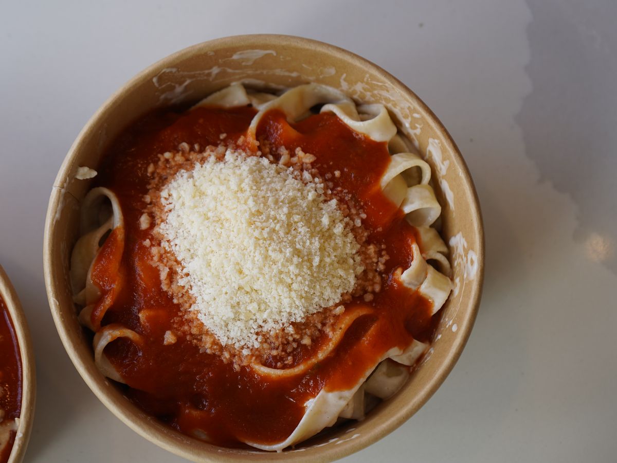 Bowl of fettuccine with tomato sauce topped with grated Parmesan at Pastasole